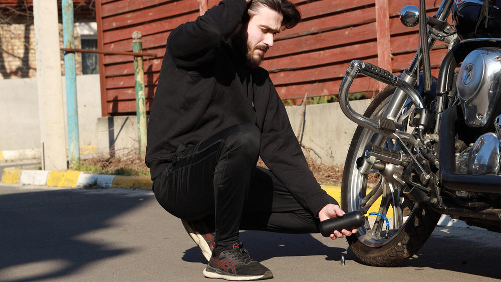a man inflating a motorcycle tire with woowind lp1 tire inflator
