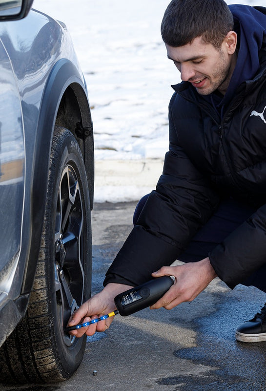 a male model using woowind lp1 inflating a car tire